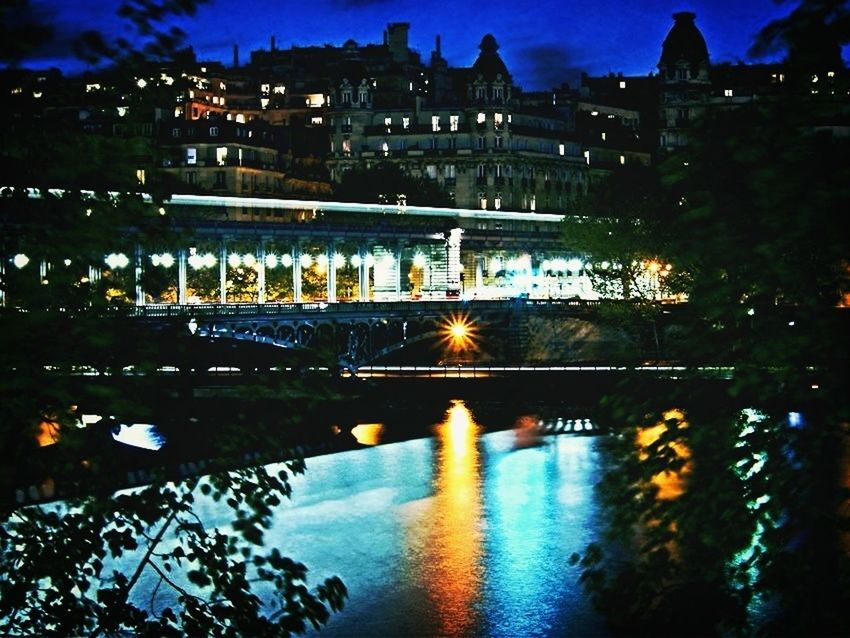 VIEW OF ILLUMINATED CITY AT NIGHT