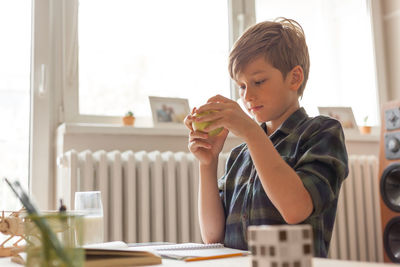 Boy sitting on table