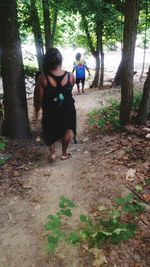 Full length of woman standing in forest