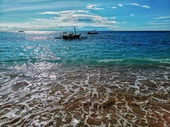 Traditional fishing boats, are anchored on the edge of the senggigi beach.