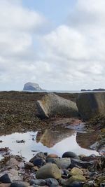 Rocks on beach against sky