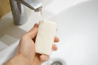 Close-up of hand holding white