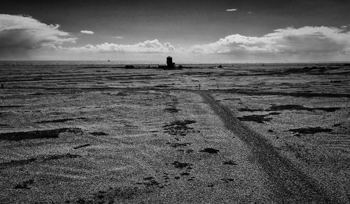 Silhouette man on beach against sky