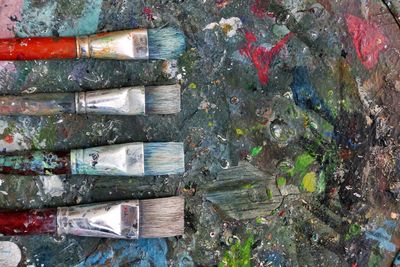 Close-up of paintbrushes on dirty table