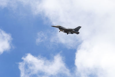 Low angle view of fighter plane flying in sky