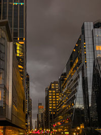 Low angle view of modern buildings in city at night