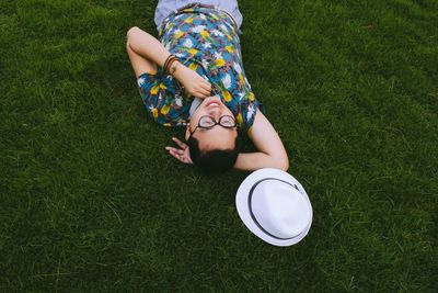 High angle view of young man lying on field in park