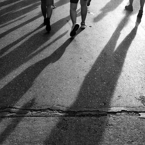 Low section of people walking on road