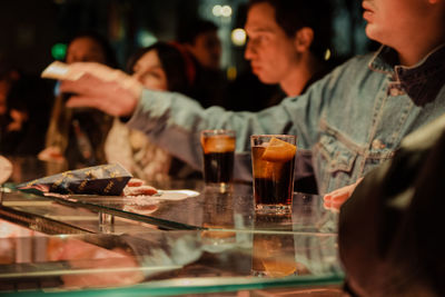 People drinking glass on table