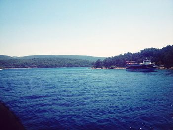 Calm sea with mountain range in background