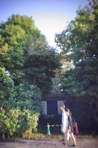 Young woman standing on tree trunk