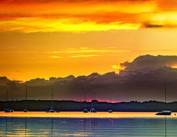 Scenic view of dramatic sky over sea during sunset