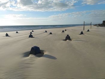 People on beach against sky