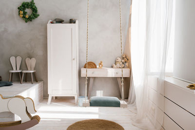 Modern interior of a children's bedroom. wardrobe, chest of drawers and toys in the scandinavian
