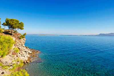 Scenic view of sea against clear blue sky