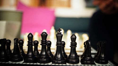 Close-up of chess pieces on table