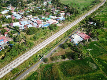 High angle view of road amidst trees and buildings