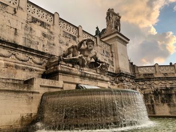 Low angle view of fountain against building