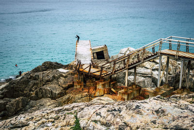 High angle view of rock formation by sea against sky