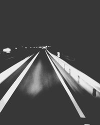 Empty road on bridge at night
