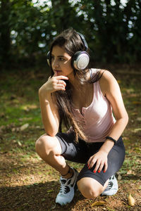 Young woman sitting on grass