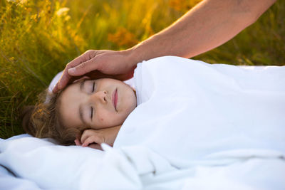 Midsection of woman lying on bed