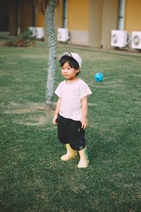 Full length of boy playing soccer at park