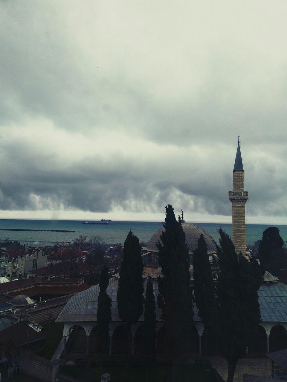 sky, architecture, building exterior, built structure, cloud - sky, sea, horizon over water, cloudy, cloud, weather, overcast, nature, scenics, water, outdoors, beauty in nature, beach, day, tranquility, roof