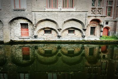 Reflection of old building in canal