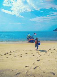 Boys on beach against sky