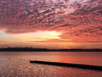 Scenic view of lake against orange sky