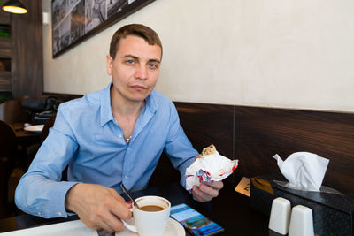 Portrait of young woman drinking coffee