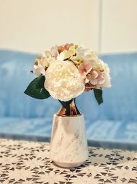 Close-up of rose flower in vase on table