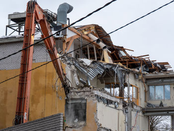 Low angle view of abandoned building against sky