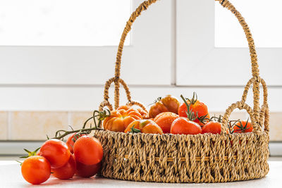 Close-up of tomatoes in basket on table