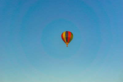 Low angle view of hot air balloon against blue sky