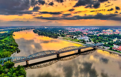 High angle view of bridge over river against sky during sunset