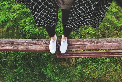 Low section of man walking on wood