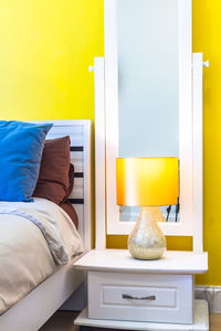 View of yellow bed in bedroom