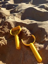 High angle view of shovel toy on sand