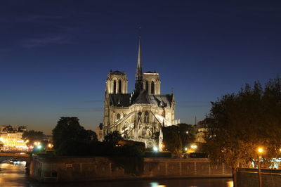 Illuminated building against sky at night