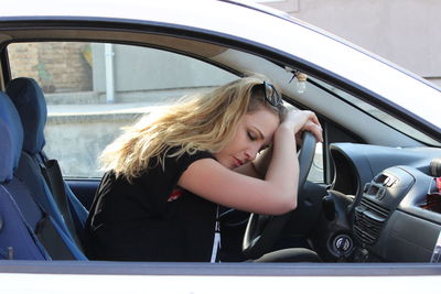 Portrait of woman sitting in car