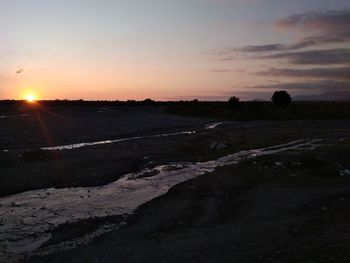 Scenic view of landscape against sky during sunset
