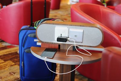 High angle view of mobile phone charging on table