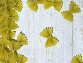 Directly above shot of farfalle pasta on wooden table