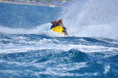 Man surfing on sea