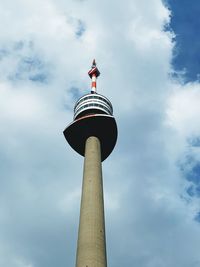 Low angle view of communications tower against sky