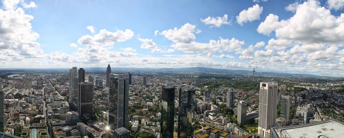 High angle view of cityscape against cloudy sky