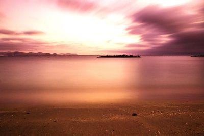 Scenic view of sea against romantic sky at sunset