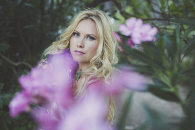 Portrait of woman with pink flower